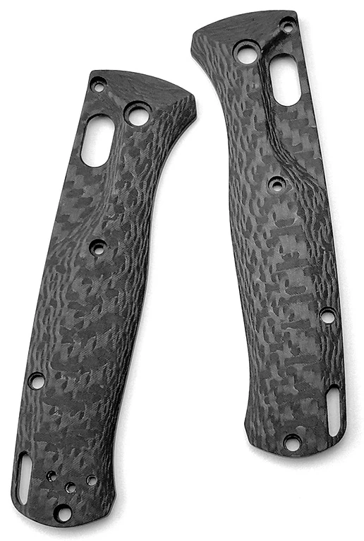 Two dark textured handle scales with circular holes and elongated openings