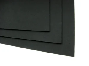 Three overlapping black textured sheet corners on a white background