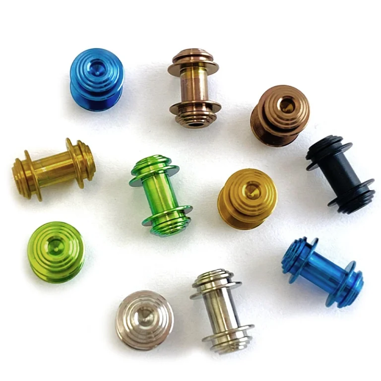 Colored spool-shaped components shown from their cylindrical sides and concentric end faces