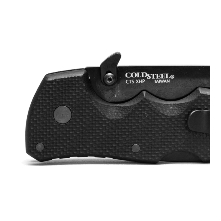 Original dark folding-knife installation view with the complete visible mounted black opening attachment, its screw and the actual blade markings; the source already crops the knife at the right edge